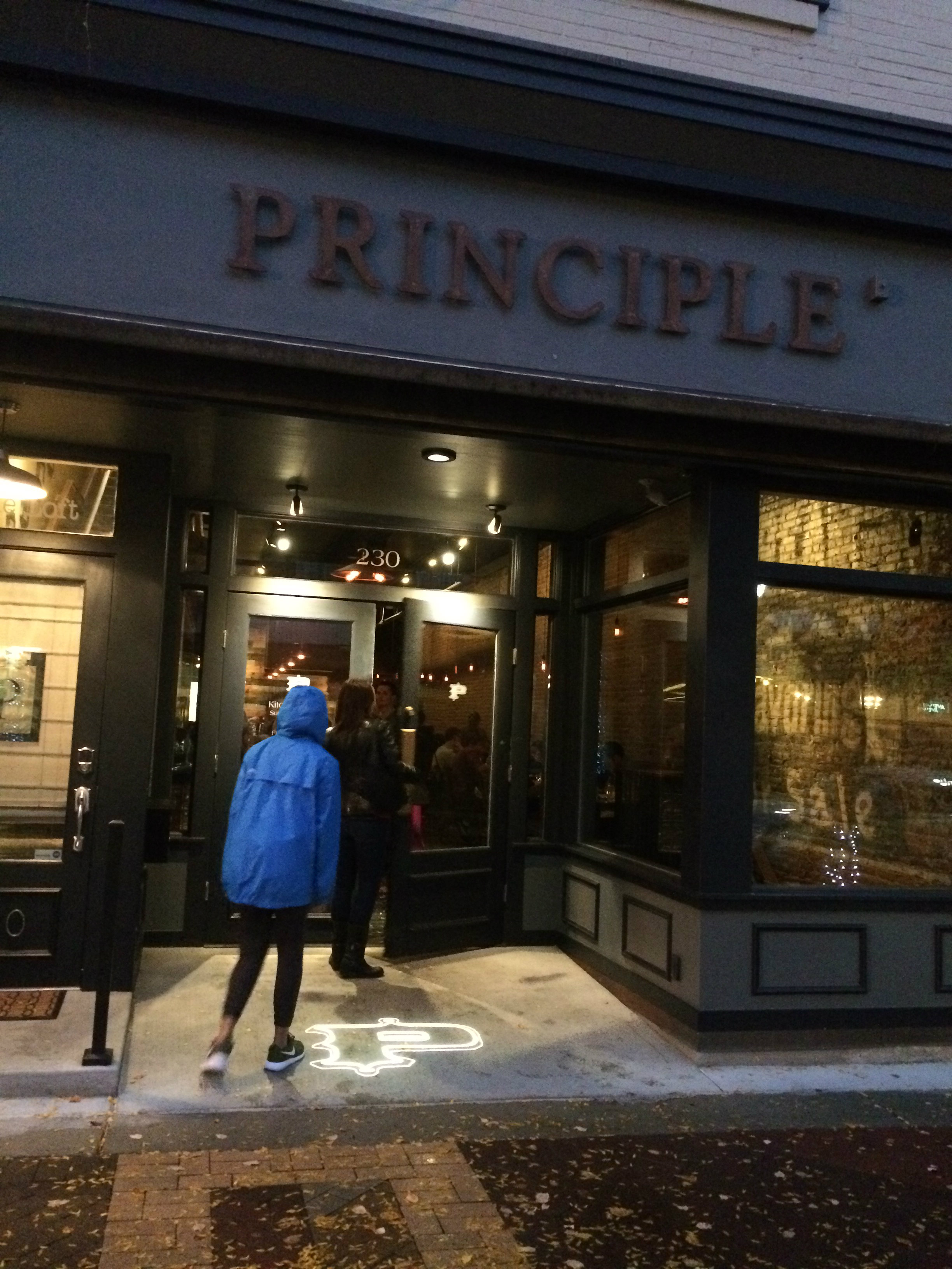 Large front windows show the crowd inside of the restaurant