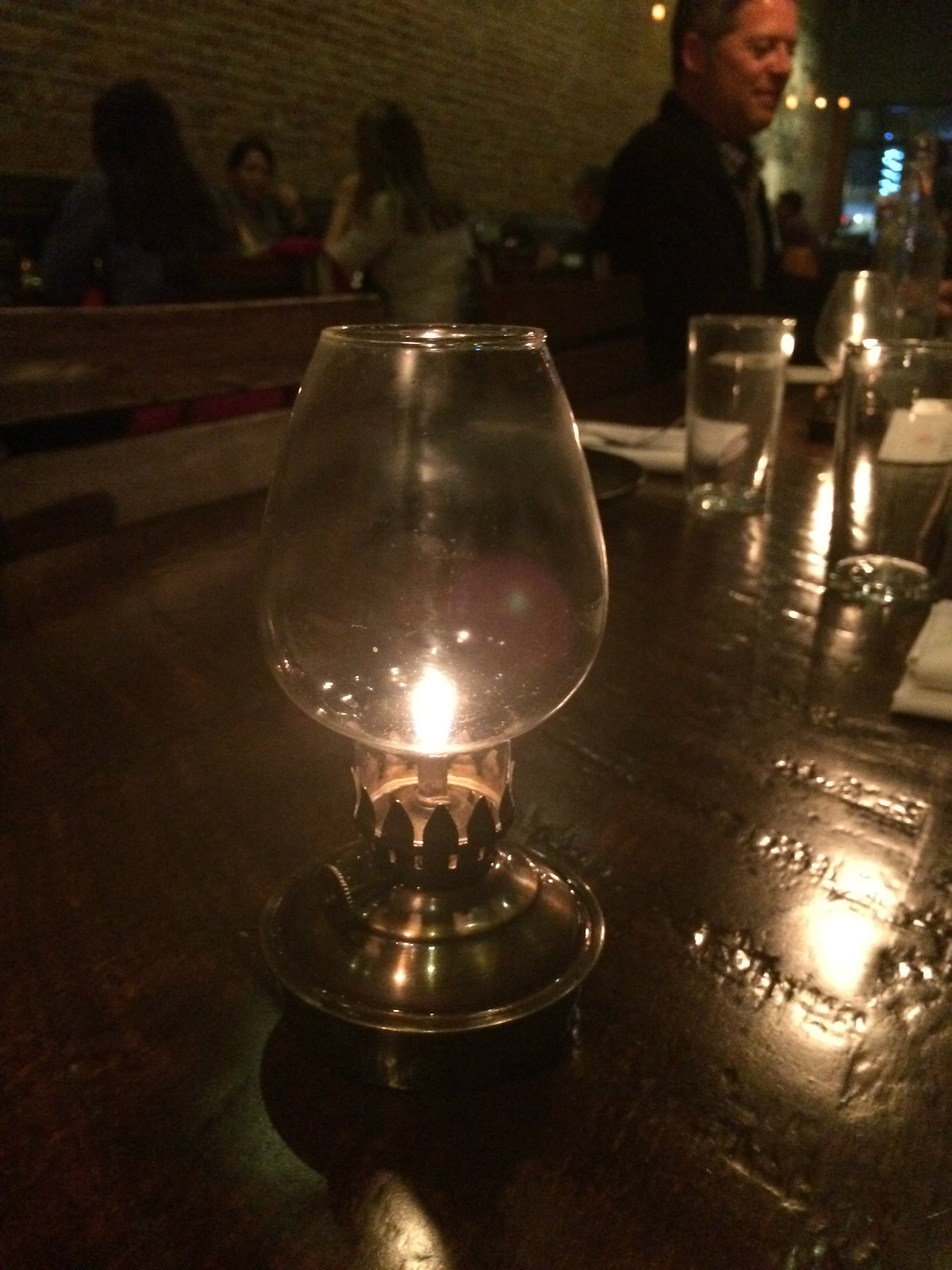 An old-fashioned candle in a glass holder on the table