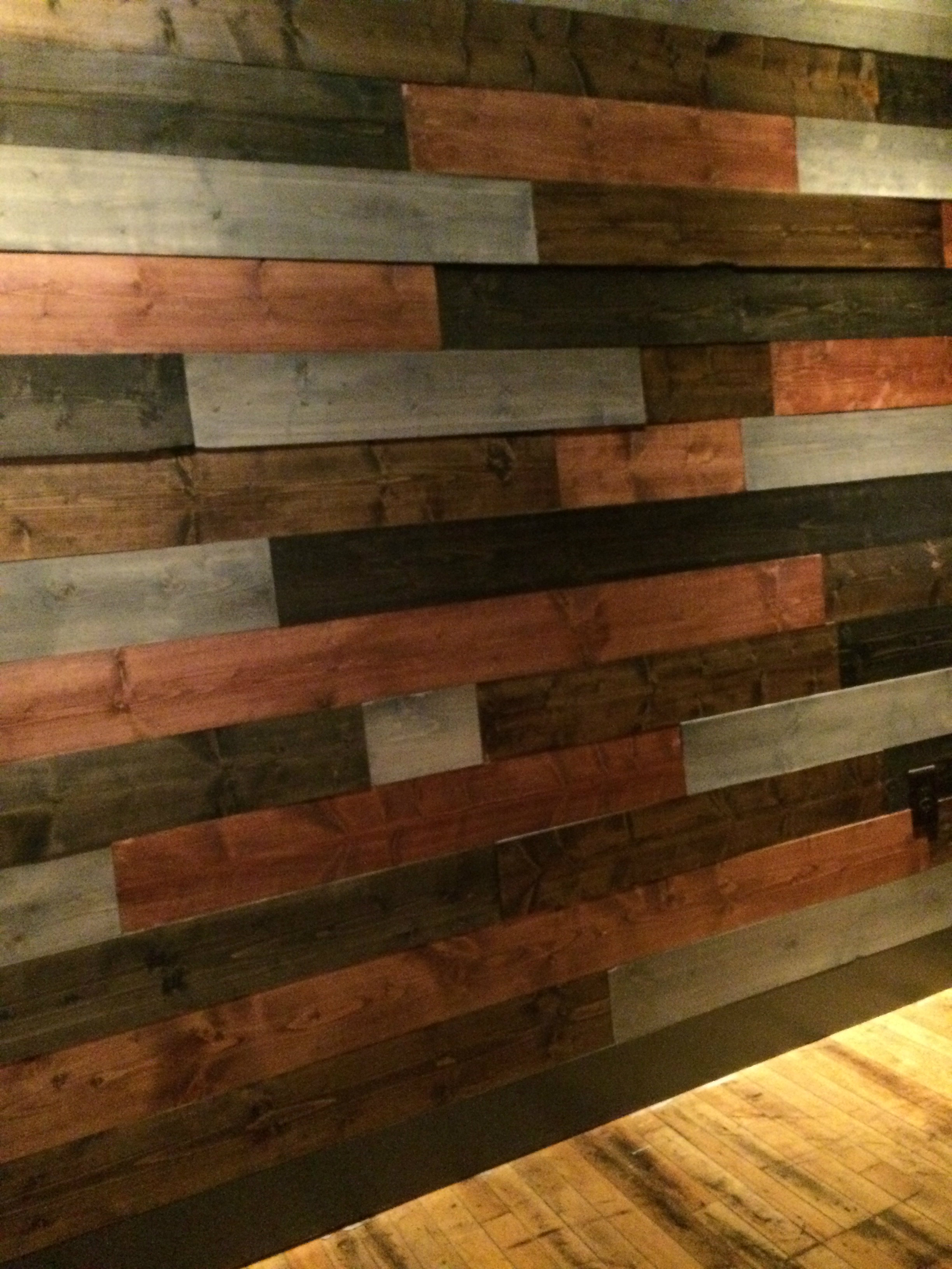 Multi-colored reclaimed wood fitted together to make a beautiful wall