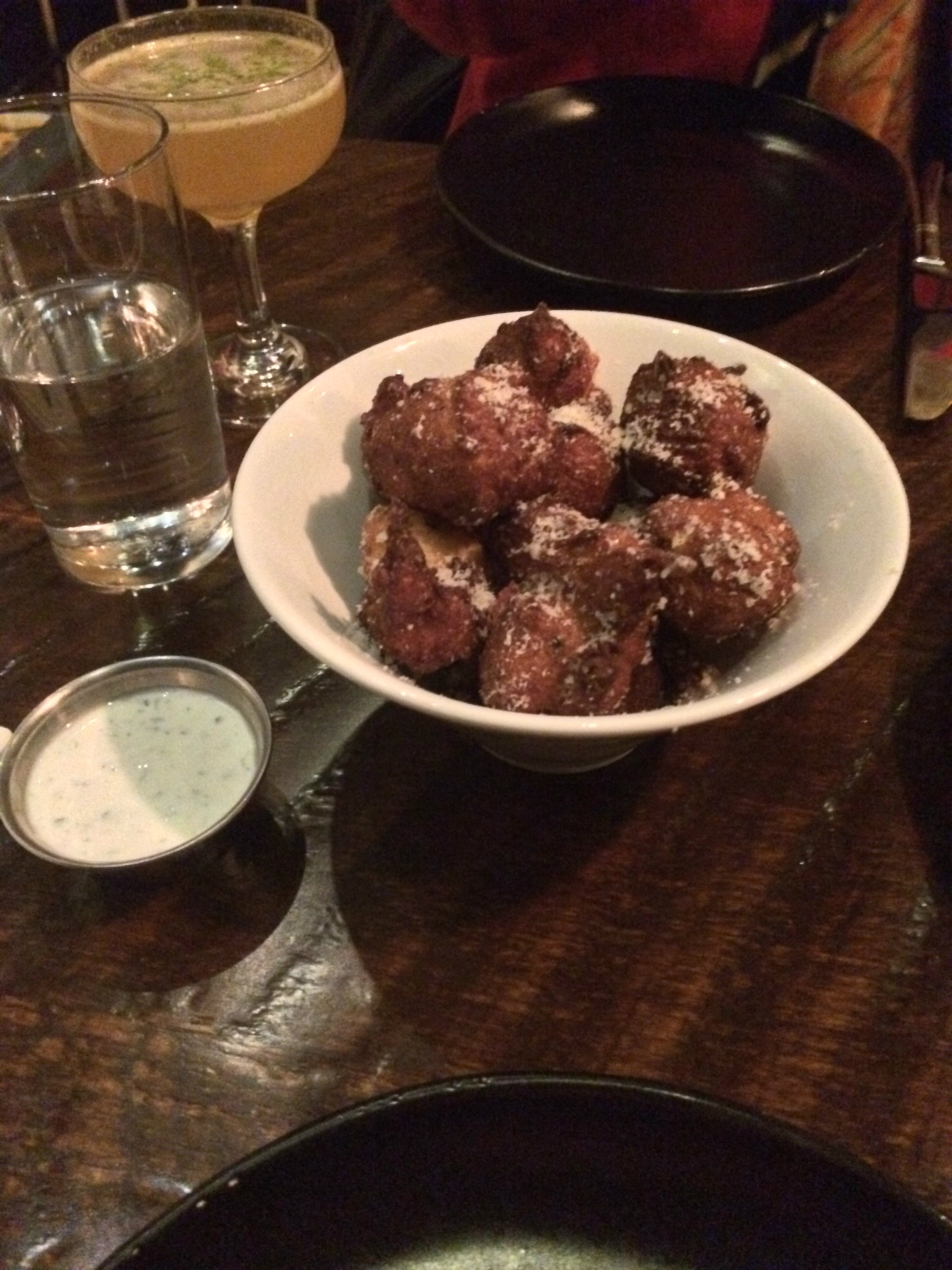 Small fried doughnut holes dusted with parmesan