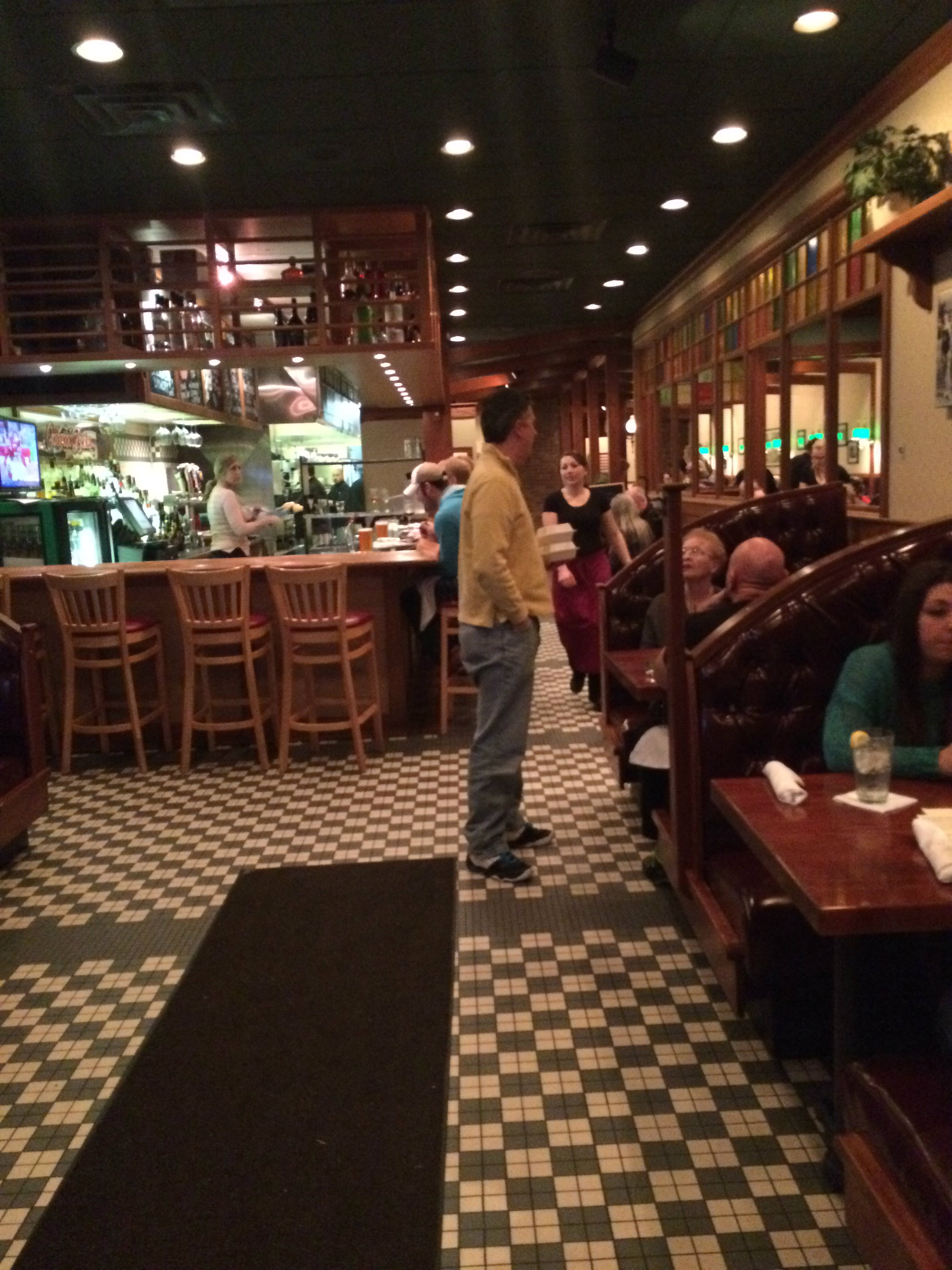 A classic-looking restaurant, with a bar on the left and boothes on the right