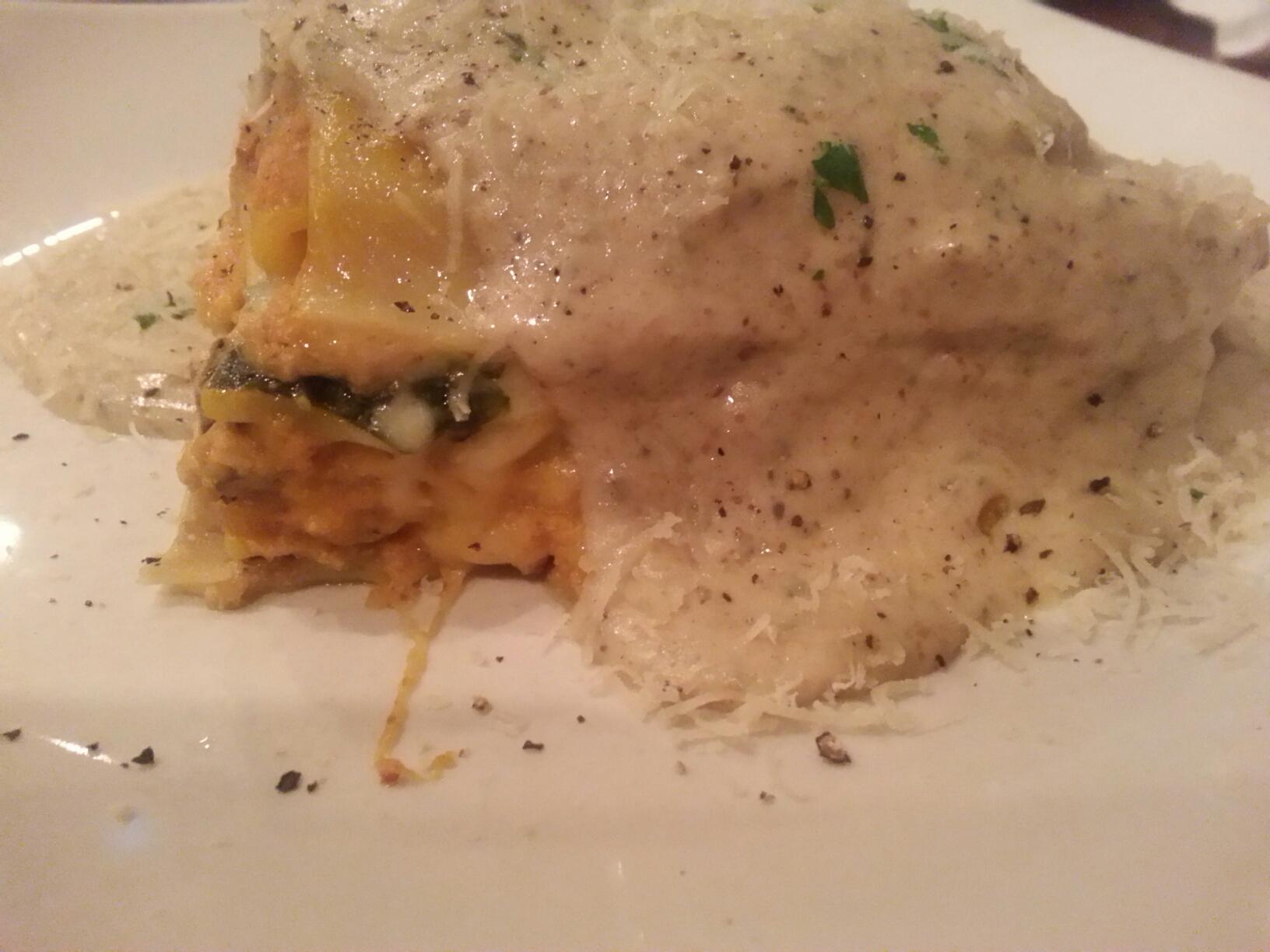 A very large peice of pumpkin and squash lasagna, covered in melted cheese