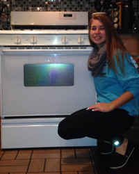 image: Grace next to her oven.