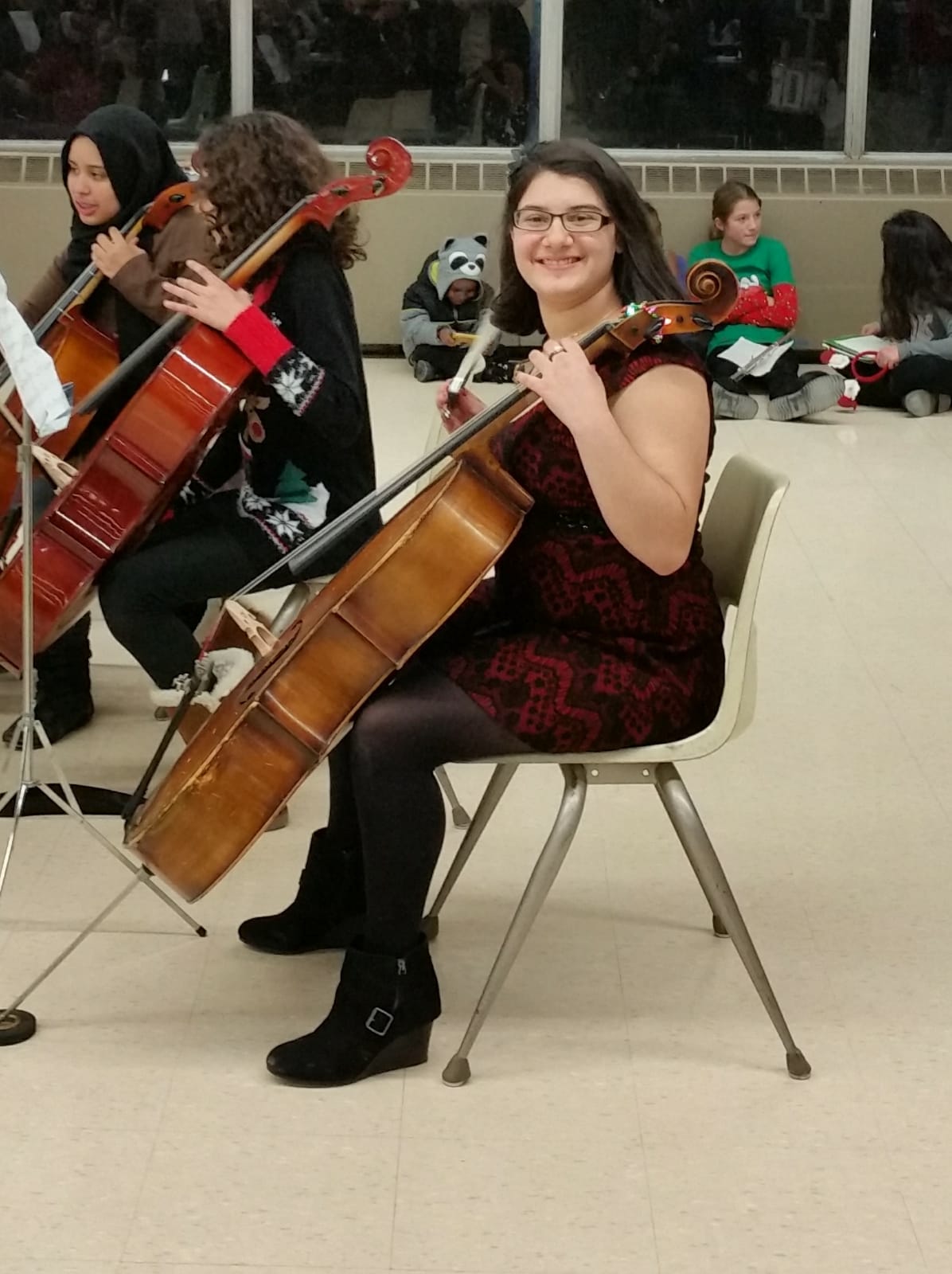 Angela sitting with her cello