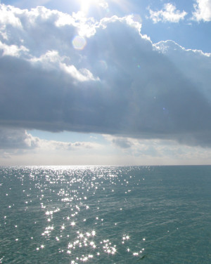 Sun breaking through the clouds 
            and making the Gulf of Mexico sparkle.