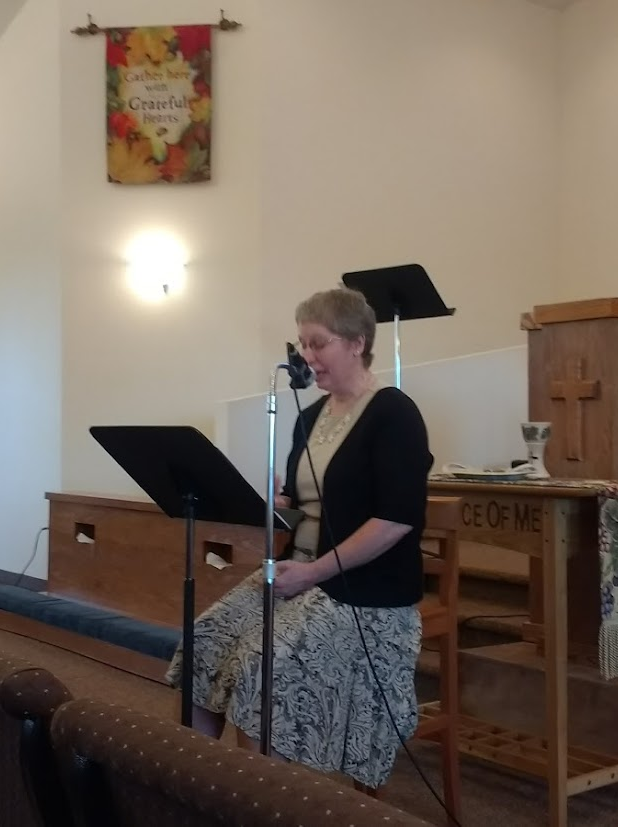 Beth Mattison speaking at a church.