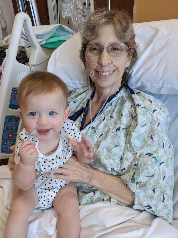 Beth Mattison in the hospital 
              holding Daniel, her grandson, Becca's child.