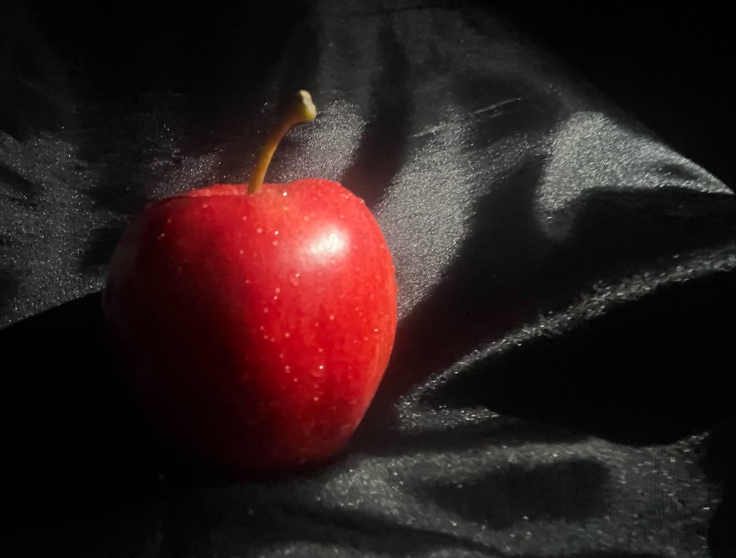 Photograph of an apple. This time, the background appears black, and the highlights don't distract from the image.