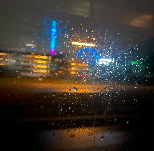 Image of a night sky scattered through a water-drop filled window.