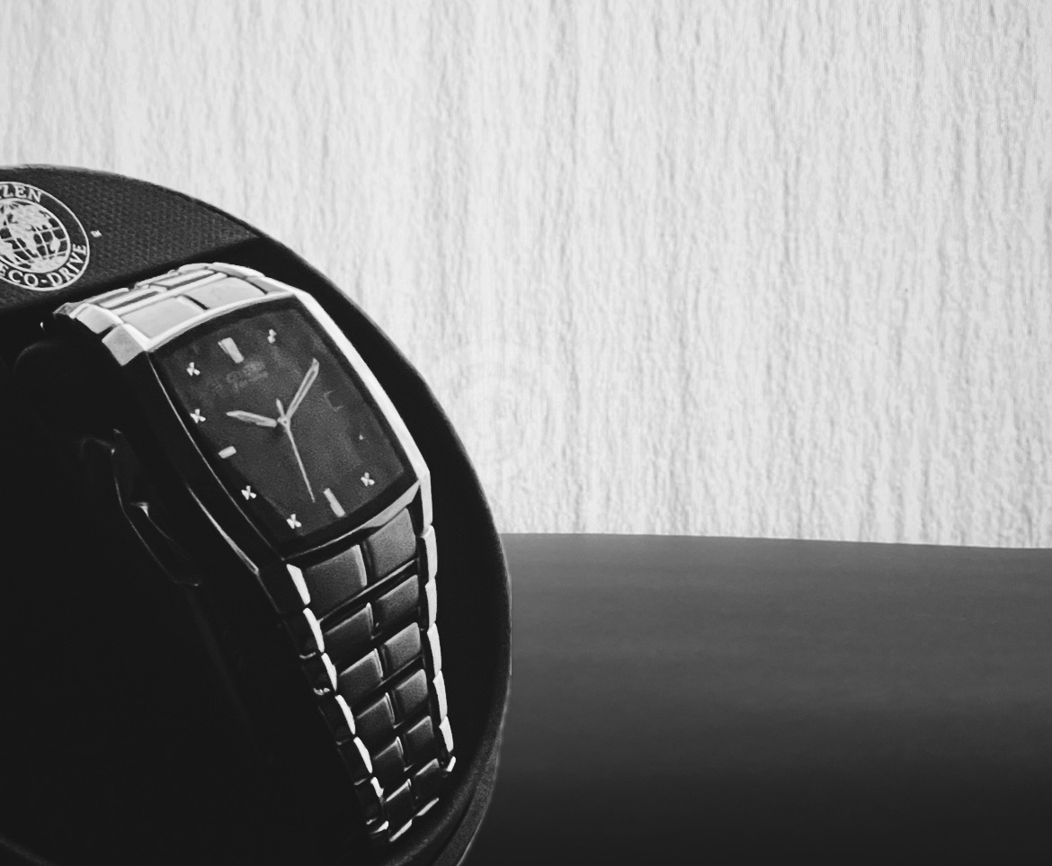 Image of a black and silver watch on a white background.